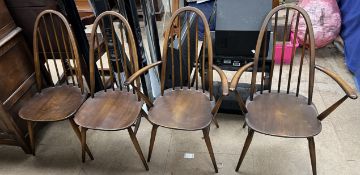 A set of four Ercol stick back dining chairs on tapering legs,