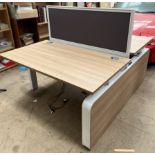 A back to back height adjustable electrical desk, with central screen, 140cm wide x 168.