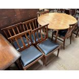 A mid 20th century G-Plan teak dining suite comprising an extending dining table and six chairs