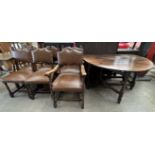 A 19th century oak gateleg dining table with a planked oval top on turned legs together with a set