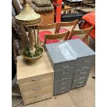A pair of grey painted filing drawers together with another cabinet and a lamp