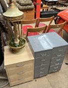 A pair of grey painted filing drawers together with another cabinet and a lamp