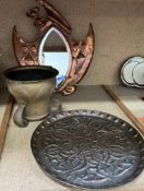 A copper framed wall mirror together with an Art Nouveau inspired jardiniere and a copper charger