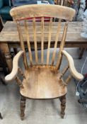 A slat back kitchen chair with a solid seat on turned legs