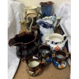 A Royal Doulton leaf moulded ewer together with a Royal Doulton Harvest ware jug and other jugs