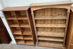 A pine bookcase with a moulded cornice above four shelves on a plinth base,