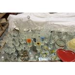 A large lot comprising a twin handled punch bowl, other glass bowls, drinking glasses, pottery mugs,