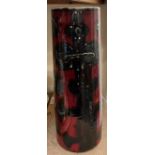 A large Poole pottery vase with a red ground and geometric patterns