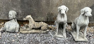 A pair of reconstituted stone models of seated hounds together another of a recumbent whippet and a