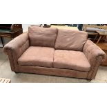 A brown leather two seater settee