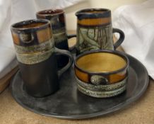 A pottery part coffee set comprising two coffee cups, cream jug,