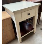 A free standing kitchen island with a square reconstituted marble top above a double sided pull