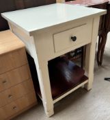 A free standing kitchen island with a square reconstituted marble top above a double sided pull