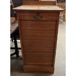 An oak tambour fronted filing cabinet with a drop front and sliding drawers, 50.