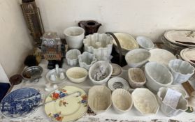A collection of pottery jelly moulds, various sizes together with a robot,