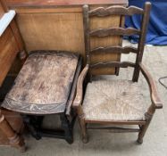 A child's ladder back chair together with a small table with a carved top