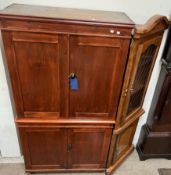 A pine linen press with a moulded cornice above two pairs of cupboard door on turned feet,