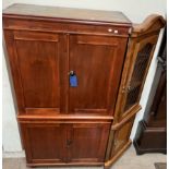 A pine linen press with a moulded cornice above two pairs of cupboard door on turned feet,