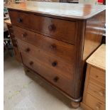 A Victorian chest with a moulded rectangular top above two short and three long drawers on turned