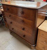 A Victorian chest with a moulded rectangular top above two short and three long drawers on turned