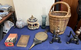 A pair of copper and cast iron andirons together with a wicker basket, bellows, books rumtopf,