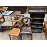 A carved oak stool with a sea creature carved front together with an oak bookcase and three