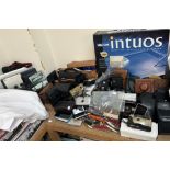 A collection of cameras including a Nikon F-301, Kodak, Olympus together with various pen knives,