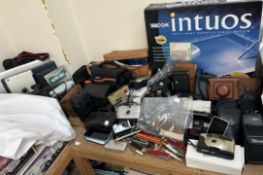 A collection of cameras including a Nikon F-301, Kodak, Olympus together with various pen knives,