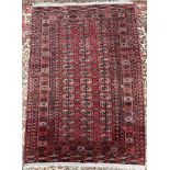 A red ground Turkoman rug, with multiple guls and guard stripes,