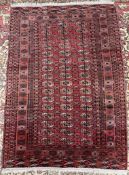 A red ground Turkoman rug, with multiple guls and guard stripes,