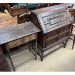 A 20th century oak bureau with a geometric panelled sloping fall above two drawers on barley twist