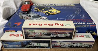 An Artin Super Looper electric power road racing model together with Hess models and a Burago