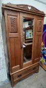 An Edwardian Satin walnut two piece bedroom suite comprising a wardrobe with a mirrored door,