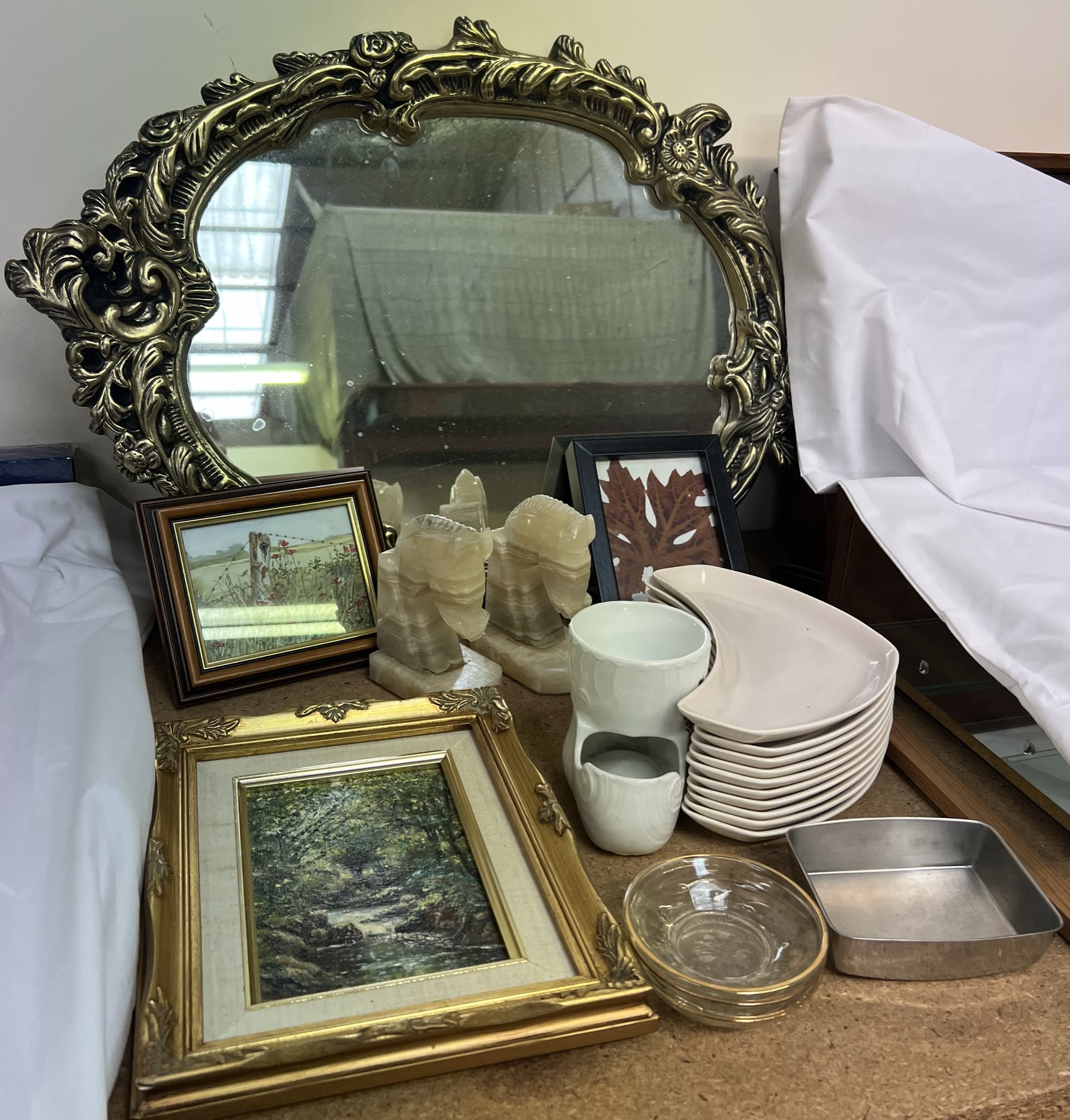 A gilt framed wall mirror together with Poole pottery dishes, pictures,