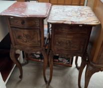 A French bedside cabinet with a shaped marble top above a drawer and a cupboard on leaf carved