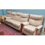 A floral upholstered three piece suite comprising a three seater settee and two chairs