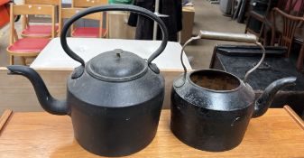 A cast iron kettle together with another
