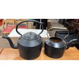 A cast iron kettle together with another