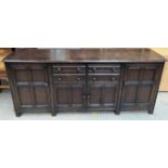 A 20th century oak sideboard with four drawers and four cupboards on square legs,