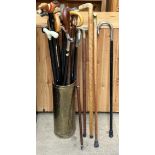 A collection of walking sticks and a brass stick stand