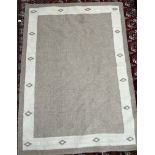 A modern wool rug in browns and creams,