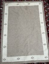A modern wool rug in browns and creams,