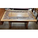 A 20th century coffee table carved with serpents,