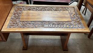 A 20th century coffee table carved with serpents,