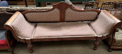 A Victorian mahogany framed double ended scroll over settee on reeded tapering legs