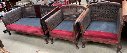 A mahogany bergere three piece suite with shell capped cabriole legs and pad feet