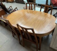 A Nathan teak dining suite comprising an extending dining table, four chairs,