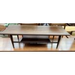 A mid 20th century teak coffee table of rectangular form with an undertier and tapering legs,