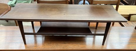 A mid 20th century teak coffee table of rectangular form with an undertier and tapering legs,