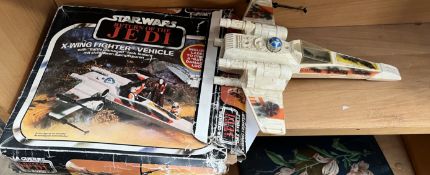 A Star Wars X-wing fighter vehicle with box